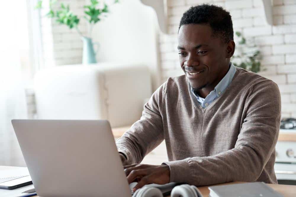 man scheduling appointment on laptop